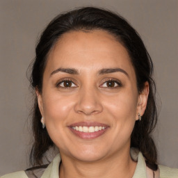 Joyful white adult female with medium  brown hair and brown eyes