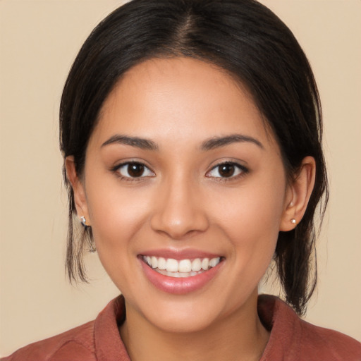 Joyful latino young-adult female with medium  brown hair and brown eyes