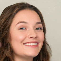 Joyful white young-adult female with long  brown hair and green eyes