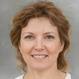 Joyful white adult female with medium  brown hair and grey eyes