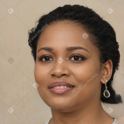 Joyful black young-adult female with long  black hair and brown eyes