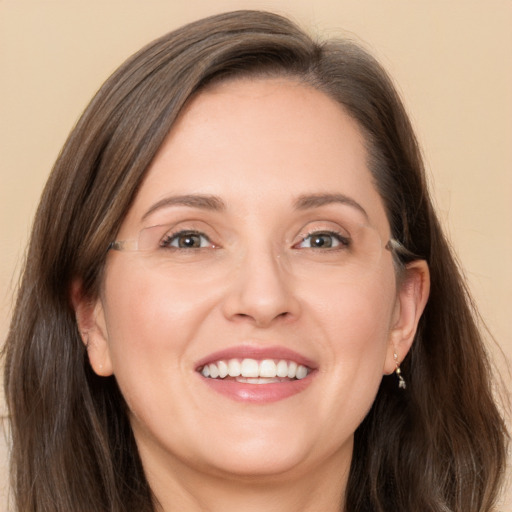 Joyful white adult female with long  brown hair and grey eyes