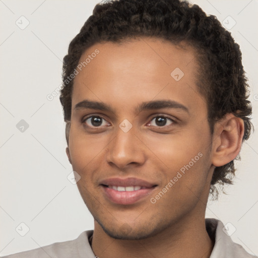 Joyful black young-adult male with short  brown hair and brown eyes