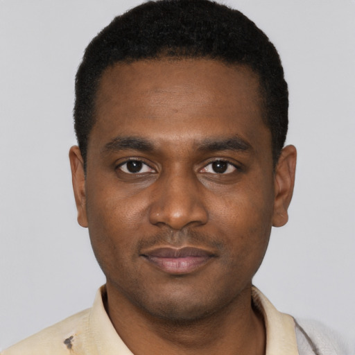 Joyful black young-adult male with short  black hair and brown eyes