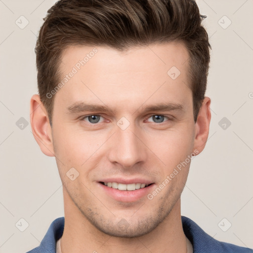 Joyful white young-adult male with short  brown hair and grey eyes