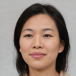 Joyful asian young-adult female with medium  brown hair and brown eyes