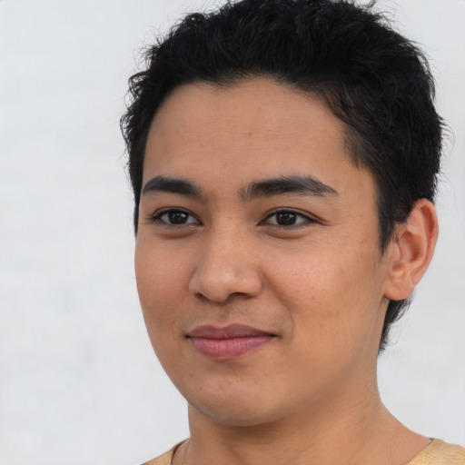 Joyful latino young-adult male with short  brown hair and brown eyes