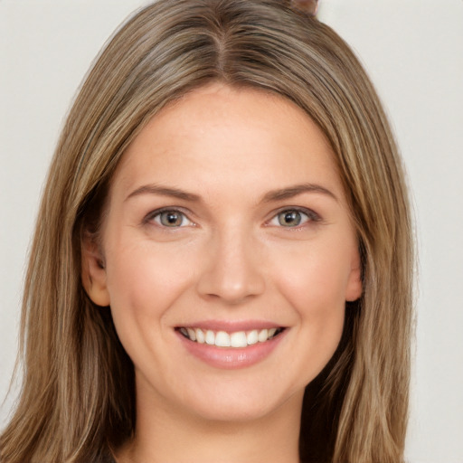 Joyful white young-adult female with long  brown hair and brown eyes