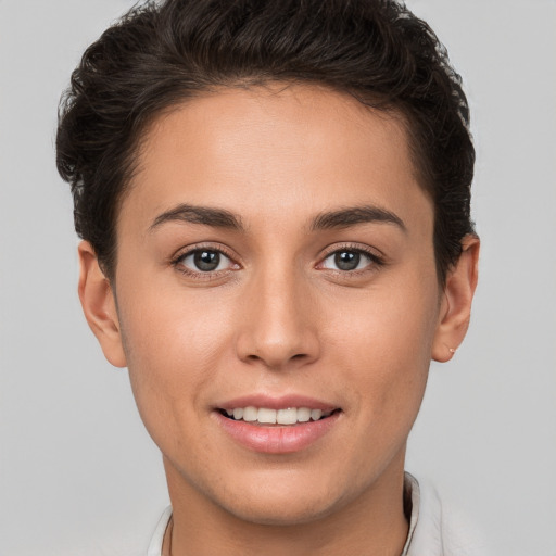 Joyful white young-adult female with short  brown hair and brown eyes