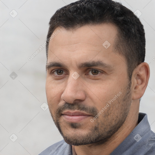 Joyful white adult male with short  black hair and brown eyes