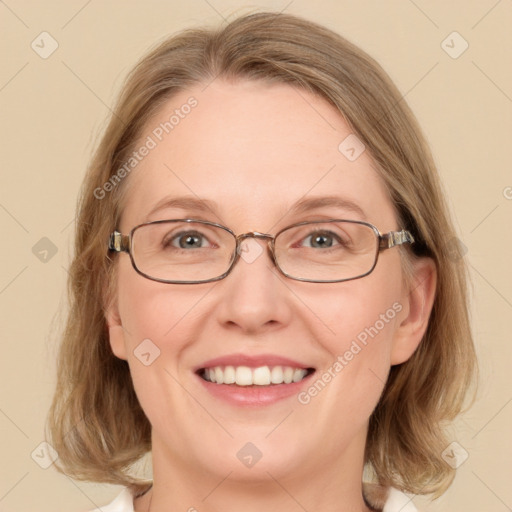 Joyful white adult female with medium  brown hair and blue eyes