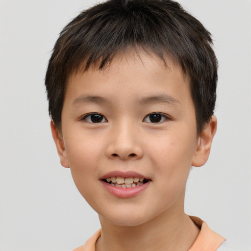 Joyful white child male with short  brown hair and brown eyes