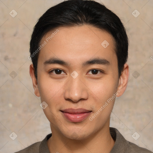 Joyful asian young-adult male with short  black hair and brown eyes