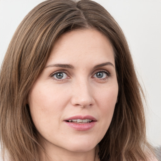 Joyful white young-adult female with long  brown hair and blue eyes