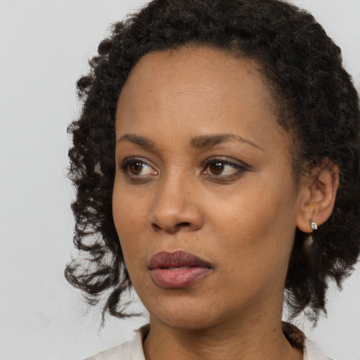 Neutral black young-adult female with medium  black hair and brown eyes