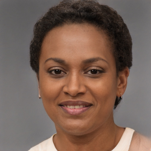 Joyful black adult female with short  brown hair and brown eyes