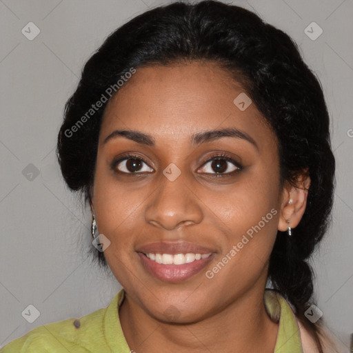 Joyful black young-adult female with long  black hair and brown eyes