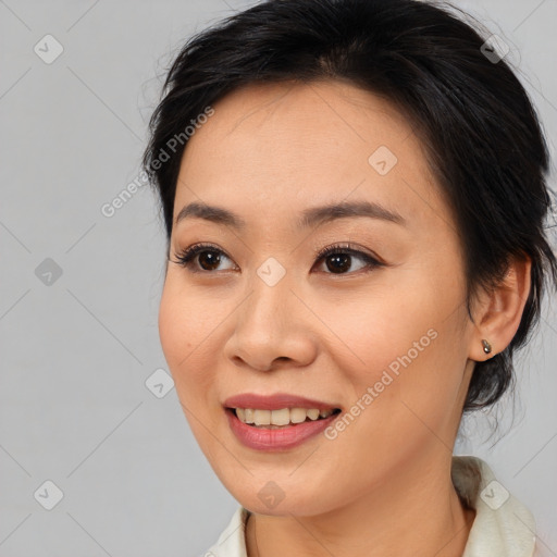 Joyful asian young-adult female with medium  brown hair and brown eyes