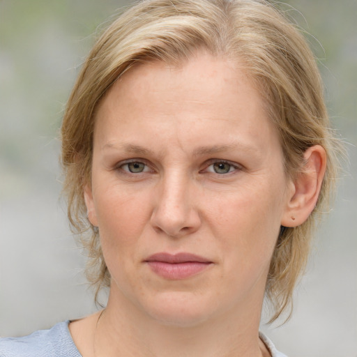 Joyful white adult female with medium  brown hair and blue eyes