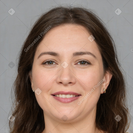 Joyful white adult female with long  brown hair and brown eyes