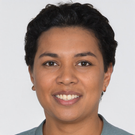 Joyful latino young-adult female with short  black hair and brown eyes