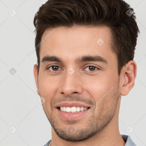 Joyful white young-adult male with short  brown hair and brown eyes