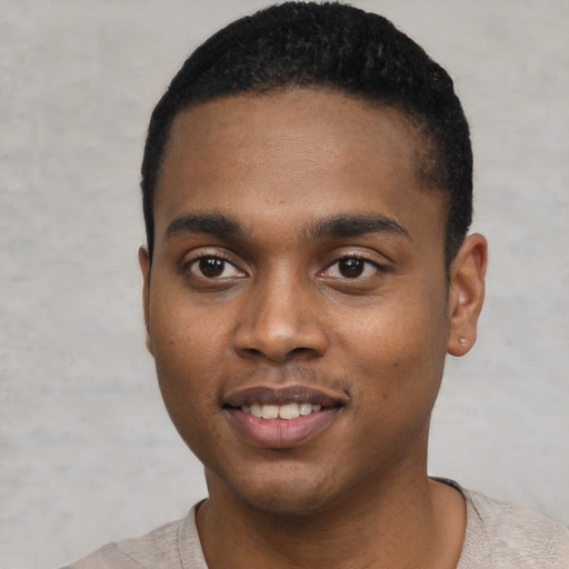 Joyful black young-adult male with short  black hair and brown eyes