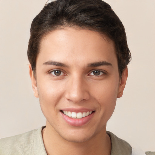 Joyful white young-adult female with short  brown hair and brown eyes