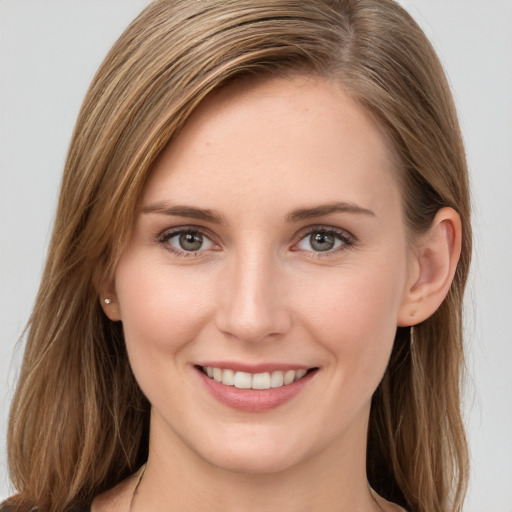 Joyful white young-adult female with long  brown hair and grey eyes