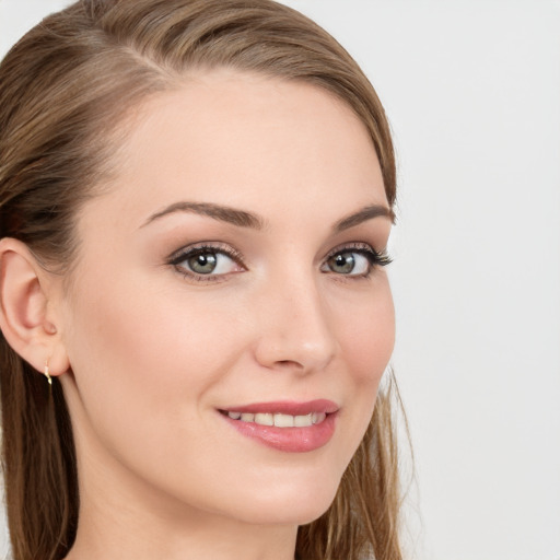 Joyful white young-adult female with long  brown hair and blue eyes