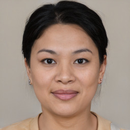 Joyful asian young-adult female with medium  brown hair and brown eyes