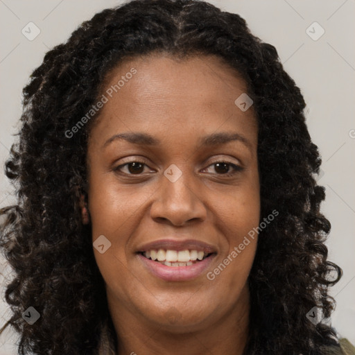 Joyful black young-adult female with long  brown hair and brown eyes