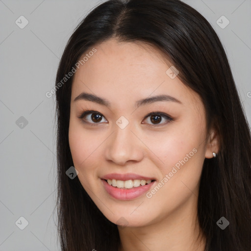 Joyful asian young-adult female with long  brown hair and brown eyes