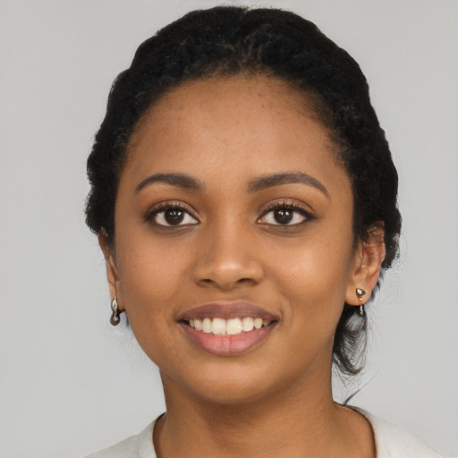 Joyful latino young-adult female with short  black hair and brown eyes