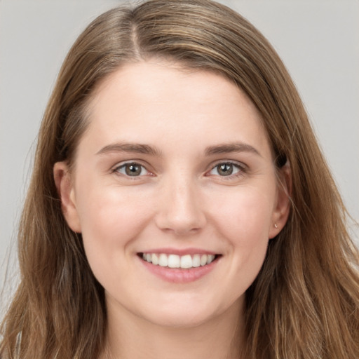 Joyful white young-adult female with long  brown hair and grey eyes