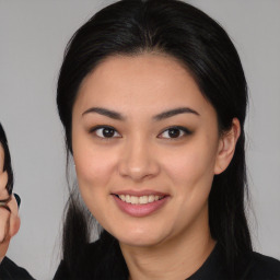 Joyful asian young-adult female with long  brown hair and brown eyes