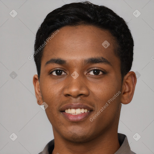 Joyful black young-adult male with short  black hair and brown eyes