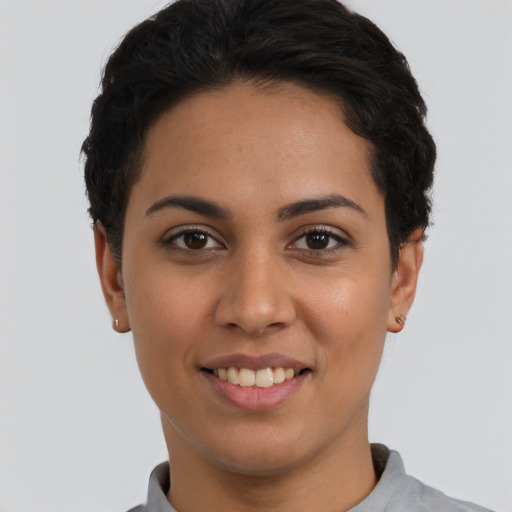 Joyful latino young-adult female with short  black hair and brown eyes