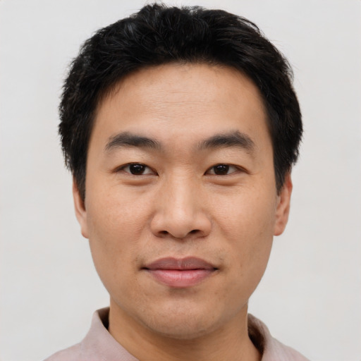Joyful asian young-adult male with short  black hair and brown eyes
