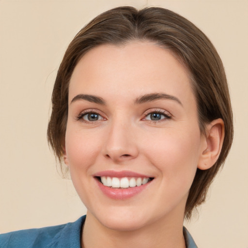 Joyful white young-adult female with medium  brown hair and blue eyes