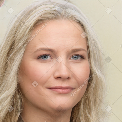 Joyful white young-adult female with long  blond hair and blue eyes