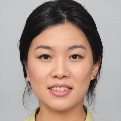 Joyful asian young-adult female with medium  brown hair and brown eyes