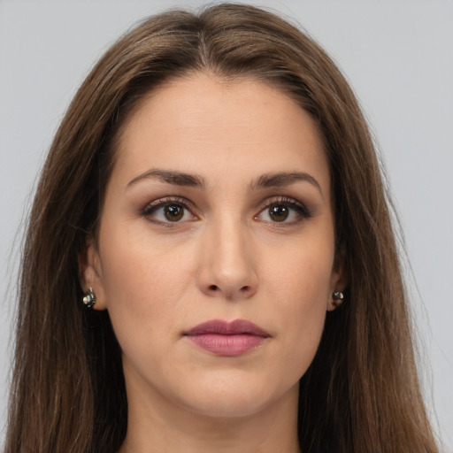 Joyful white young-adult female with long  brown hair and brown eyes