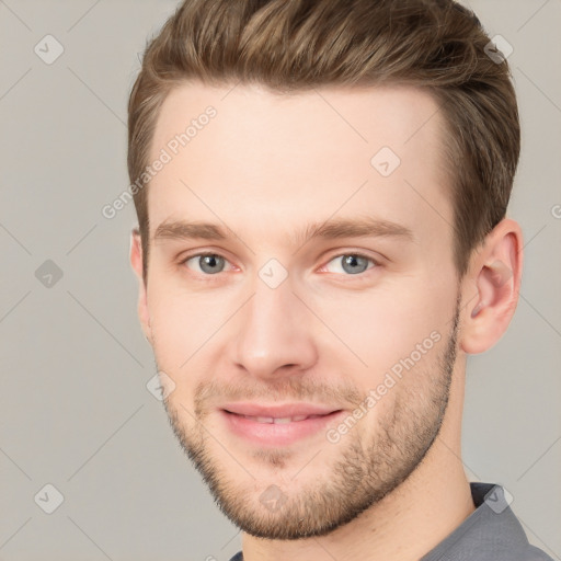 Joyful white young-adult male with short  brown hair and grey eyes