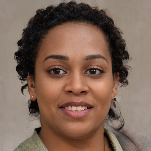 Joyful black young-adult female with medium  brown hair and brown eyes