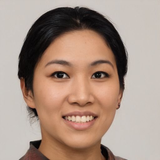 Joyful asian young-adult female with medium  black hair and brown eyes