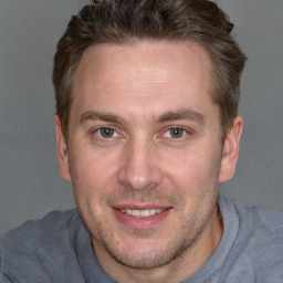 Joyful white adult male with short  brown hair and brown eyes
