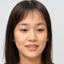 Joyful asian young-adult female with long  brown hair and brown eyes