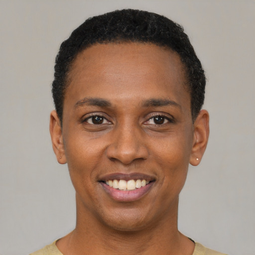 Joyful black young-adult female with short  black hair and brown eyes