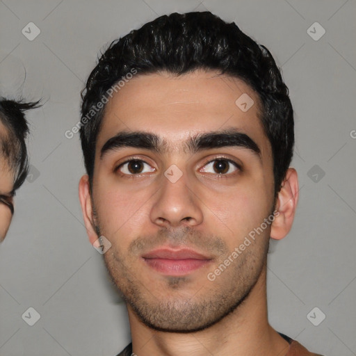 Joyful white young-adult male with short  black hair and brown eyes